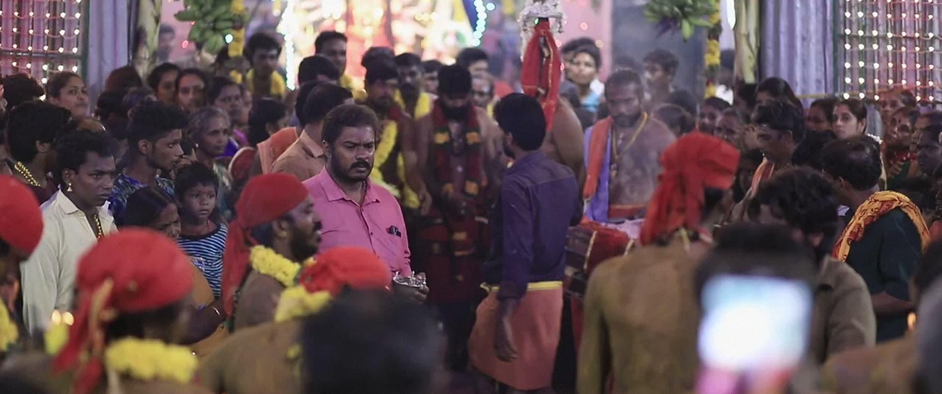 A large crowd gathered tightly together at a festival.